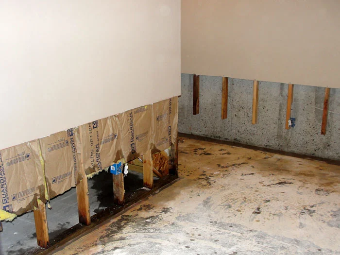 Fixing water-damaged drywall by removing the damaged area and patching with joint compound